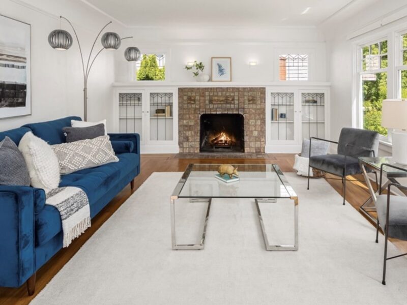 Bright open living room with original Batchelder Tile fireplace