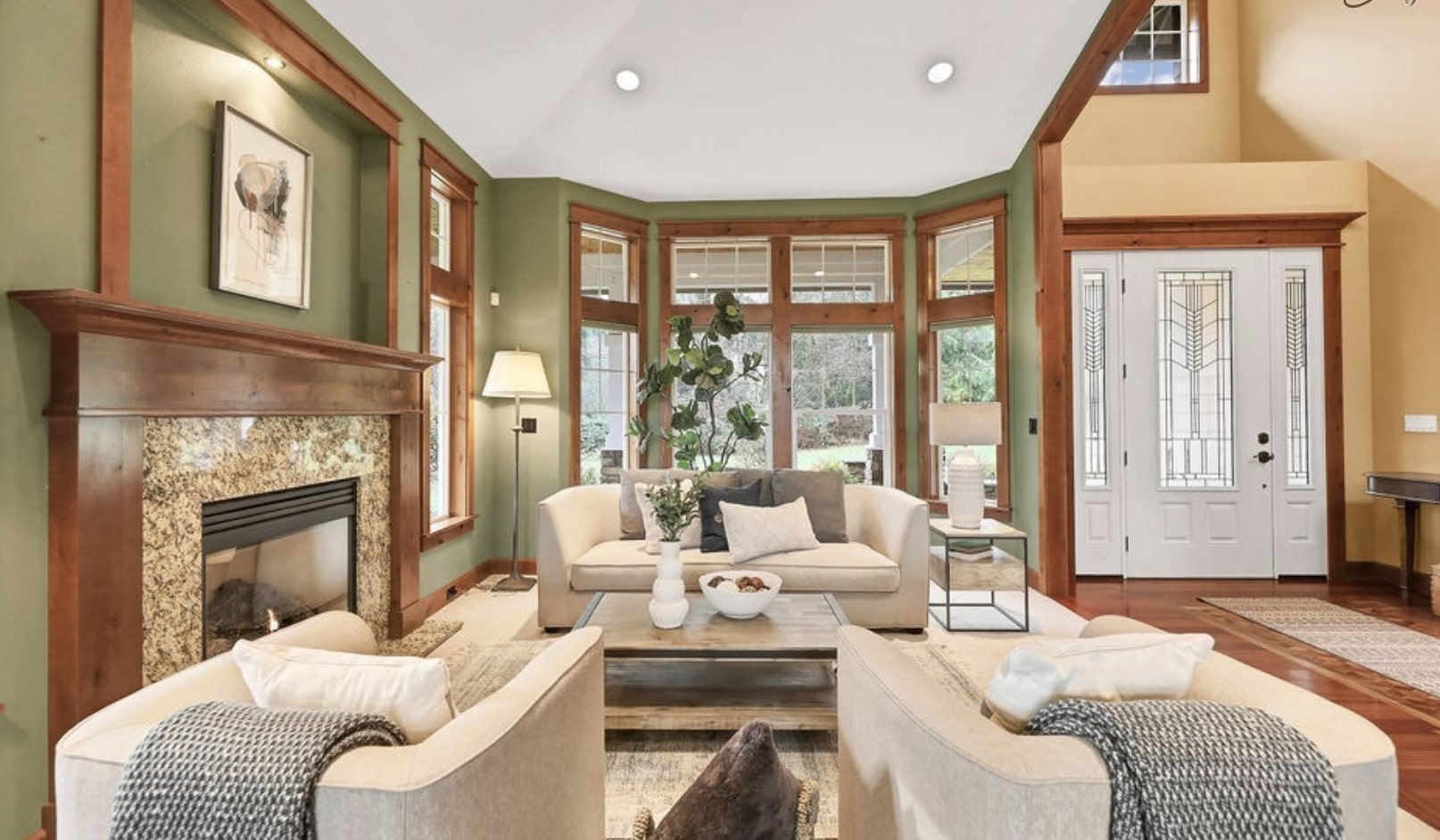 Handsome wood work showcases the cozy seating arrangement of this formal living room