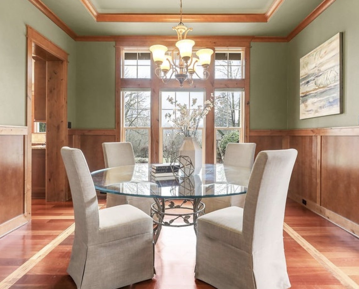 The elegant light filled formal dining space featuring handsome wood finishes