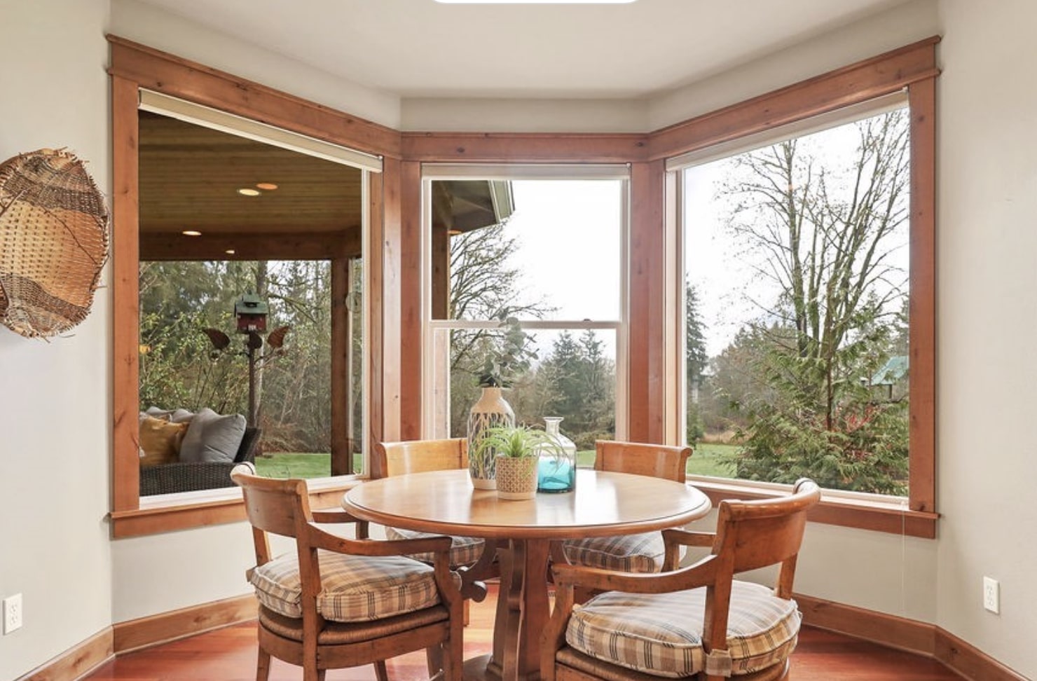 Sunny casual dining nook featuring full garden views