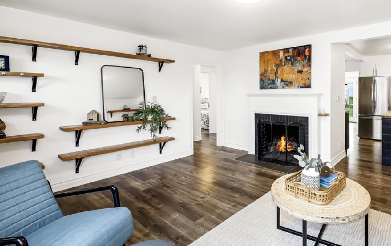 Modern farmhouse style enhance this entryway featuring floating shelves and original fireplace